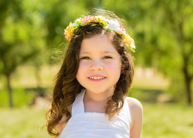close up of little girl with flower wreath